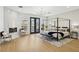 A luxurious main bedroom with a modern chandelier, fireplace, floor to ceiling windows, and access to a balcony at 2469 Sun Reef Rd, Las Vegas, NV 89128