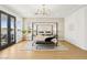 A luxurious main bedroom with a modern chandelier, floor to ceiling windows with lake view, and modern decor at 2469 Sun Reef Rd, Las Vegas, NV 89128