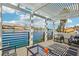 Covered patio overlooking a scenic lake featuring a modern seating area at 2469 Sun Reef Rd, Las Vegas, NV 89128