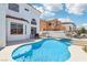 Inviting backyard with a sparkling pool, outdoor dining, and BBQ area, ideal for entertaining guests at 2469 Sun Reef Rd, Las Vegas, NV 89128