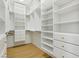 Spacious walk-in closet with custom shelving, drawers, and ample storage space at 2469 Sun Reef Rd, Las Vegas, NV 89128