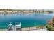 Scenic waterfront view featuring a private dock extending onto the tranquil water at 2469 Sun Reef Rd, Las Vegas, NV 89128