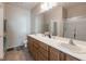 Bathroom with dual sinks, spacious vanity, and glass-enclosed shower at 2473 Luminous Stars St, Henderson, NV 89044