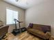 Functional bedroom with hardwood floors, closet, and room for a couch and treadmill at 2473 Luminous Stars St, Henderson, NV 89044