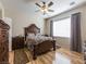Spacious bedroom with wood floors, ceiling fan, and a large window providing natural light at 2473 Luminous Stars St, Henderson, NV 89044