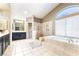 Bright bathroom with dual sink vanity, soaking tub, and step-in shower with marble surround at 259 Rockwell Springs Ct, Henderson, NV 89012