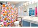 Compact bathroom featuring a shower with a colorful curtain and single sink at 259 Rockwell Springs Ct, Henderson, NV 89012