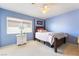 Bedroom with a four-poster bed, white nightstand and blue walls at 259 Rockwell Springs Ct, Henderson, NV 89012