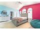 Bright bedroom with colorful walls, vaulted ceilings, and a tufted gray bed at 259 Rockwell Springs Ct, Henderson, NV 89012
