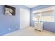 Bright bedroom featuring blue walls, white closet doors, and light-colored carpet at 259 Rockwell Springs Ct, Henderson, NV 89012