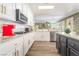 Modern kitchen with white cabinets, gold hardware, stainless appliances, and granite countertops at 259 Rockwell Springs Ct, Henderson, NV 89012