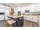 The kitchen showcases white cabinets, black island, stainless steel appliances, and granite counters at 259 Rockwell Springs Ct, Henderson, NV 89012