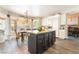 The kitchen features white cabinets, black island, stainless steel appliances, and granite counters at 259 Rockwell Springs Ct, Henderson, NV 89012
