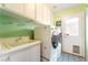 Well-equipped laundry room with a sink, washer, dryer, and door to the backyard at 259 Rockwell Springs Ct, Henderson, NV 89012