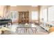 Comfortable living room with a piano, built-in display cabinet, and ample natural light at 259 Rockwell Springs Ct, Henderson, NV 89012