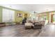 Spacious living room with green walls, plantation shutters, massage chair and access to an outdoor patio at 259 Rockwell Springs Ct, Henderson, NV 89012