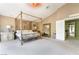 Spacious main bedroom featuring a large bed with ornate details and neutral color scheme at 259 Rockwell Springs Ct, Henderson, NV 89012