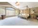 Spacious main bedroom featuring a four-poster bed, vaulted ceilings, and large windows at 259 Rockwell Springs Ct, Henderson, NV 89012