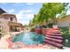 Wonderful backyard pool has rock trim, waterfall, and elegant landscaping at 259 Rockwell Springs Ct, Henderson, NV 89012