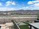 Expansive backyard with a pool, spa, and outdoor living space, offering stunning views of the surrounding mountains and neighborhood at 2714 Frabiele St, Henderson, NV 89044