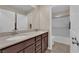 Bathroom vanity with double sinks, a large mirror, and a separated shower area at 2714 Frabiele St, Henderson, NV 89044