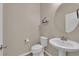 Cozy powder room with a pedestal sink, round mirror, and modern fixtures; efficiently designed at 2714 Frabiele St, Henderson, NV 89044