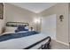 Cozy bedroom featuring a comfortable bed, soft lighting, and a closet with sliding doors at 2714 Frabiele St, Henderson, NV 89044