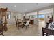 Elegant dining room with a glass table, comfortable seating, and an open layout into the living areas at 2714 Frabiele St, Henderson, NV 89044