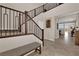 Welcoming entryway featuring a staircase, bench seating, high ceilings, and access to living spaces at 2714 Frabiele St, Henderson, NV 89044