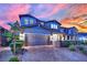 Beautiful two-story home with a brick driveway, manicured landscaping, and an attached two-car garage at 2714 Frabiele St, Henderson, NV 89044