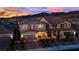 Stunning two-story home at dusk with warm exterior lighting and a charming front porch in a quiet neighborhood at 2714 Frabiele St, Henderson, NV 89044