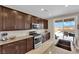 Well-appointed kitchen featuring stainless steel appliances, granite countertops, and access to the backyard pool at 2714 Frabiele St, Henderson, NV 89044