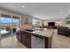 Kitchen with a large granite island, stainless appliances, and sliding glass door to backyard at 2714 Frabiele St, Henderson, NV 89044