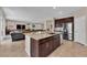 Modern kitchen with a large island, stainless steel appliances, and seamless flow into the living room at 2714 Frabiele St, Henderson, NV 89044