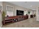Living room with entertainment center, tile floors, neutral walls, and bright, natural light at 2714 Frabiele St, Henderson, NV 89044
