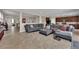 Spacious living room with gray sofas and a large tiled floor is perfect for entertaining guests at 2714 Frabiele St, Henderson, NV 89044