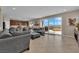 Comfortable living room with stylish sectional couch, and sliding glass doors opening to the outdoor patio at 2714 Frabiele St, Henderson, NV 89044