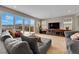Comfortable living room featuring a plush sofa with views from the sliding glass doors to the backyard at 2714 Frabiele St, Henderson, NV 89044