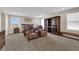 A spacious main bedroom with large windows, carpet flooring, and comfortable leather armchairs at 2714 Frabiele St, Henderson, NV 89044