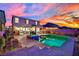 Stunning backyard with a pool, jacuzzi and spacious patio, perfect for outdoor entertaining at sunset at 2714 Frabiele St, Henderson, NV 89044