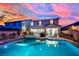 Beautiful backyard with a sparkling pool, inviting hot tub, and well-maintained landscaping under sunset skies at 2714 Frabiele St, Henderson, NV 89044