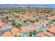 Picturesque aerial view of a neighborhood with terracotta-roofed homes, pools, and mountain backdrop at 2752 Devita Cir, Las Vegas, NV 89117