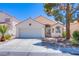 Charming single-story home with a well-maintained front yard and a two-car garage at 2752 Devita Cir, Las Vegas, NV 89117