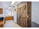Traditional kitchen featuring wood cabinets, tiled floors, and a rustic wood pantry with barn doors at 2752 Devita Cir, Las Vegas, NV 89117