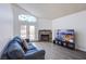 Comfortable living room with a cozy fireplace, French doors, and contemporary decor and hardwood flooring at 2752 Devita Cir, Las Vegas, NV 89117