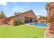 Expansive backyard featuring a pool, patio, grassy area, pergola, and well-manicured landscaping at 286 Bowsprit Ct, Las Vegas, NV 89183