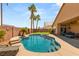 Lush backyard with a sparkling swimming pool and lounge chair, perfect for relaxation at 286 Bowsprit Ct, Las Vegas, NV 89183