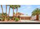 Charming single-story home with mature palm trees, a tile roof, and a three-car garage at 286 Bowsprit Ct, Las Vegas, NV 89183