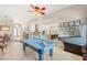 Bright game room features a pool table, retro video game machine, and opens up to the kitchen and living room at 286 Bowsprit Ct, Las Vegas, NV 89183