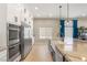Gourmet kitchen with stainless steel appliances, custom cabinets, large island with sink, and tile floors at 286 Bowsprit Ct, Las Vegas, NV 89183